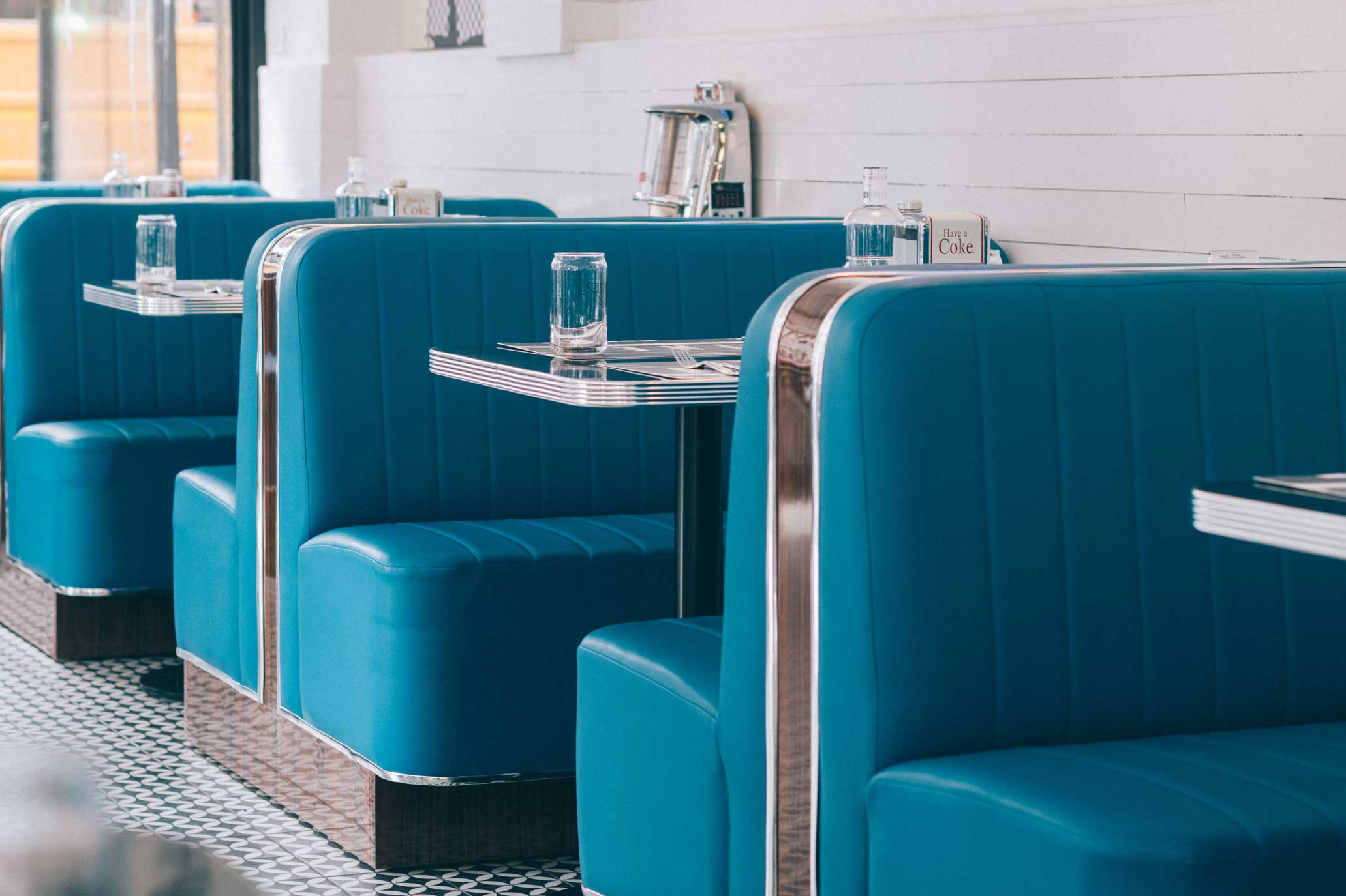 Step into the nostalgic yet modern interiors of Diner 24 NYC, a top-rated diner in NYC that seamlessly blends retro charm with contemporary style. The vibrant blue booths, accented by polished chrome edges, provide a cozy and inviting atmosphere, perfect for savoring NYC’s favorite comfort food. Whether you’re looking for the best American diner experience, vegan-friendly breakfast spots in NYC, or indulging in affordable comfort food, these iconic booths set the stage for a memorable dining experience. Known for serving the best burgers near you, late-night dining options, and the best NYC cheeseburger, Diner 24 NYC is a 24/7 destination for food lovers seeking high-quality diner food in Manhattan.